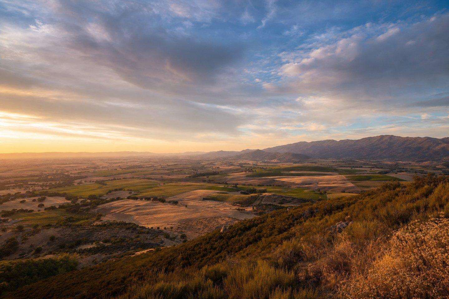 A wide view over Kern County's varied landscape, from valley farmland toward distant mountains (AI-generated image)