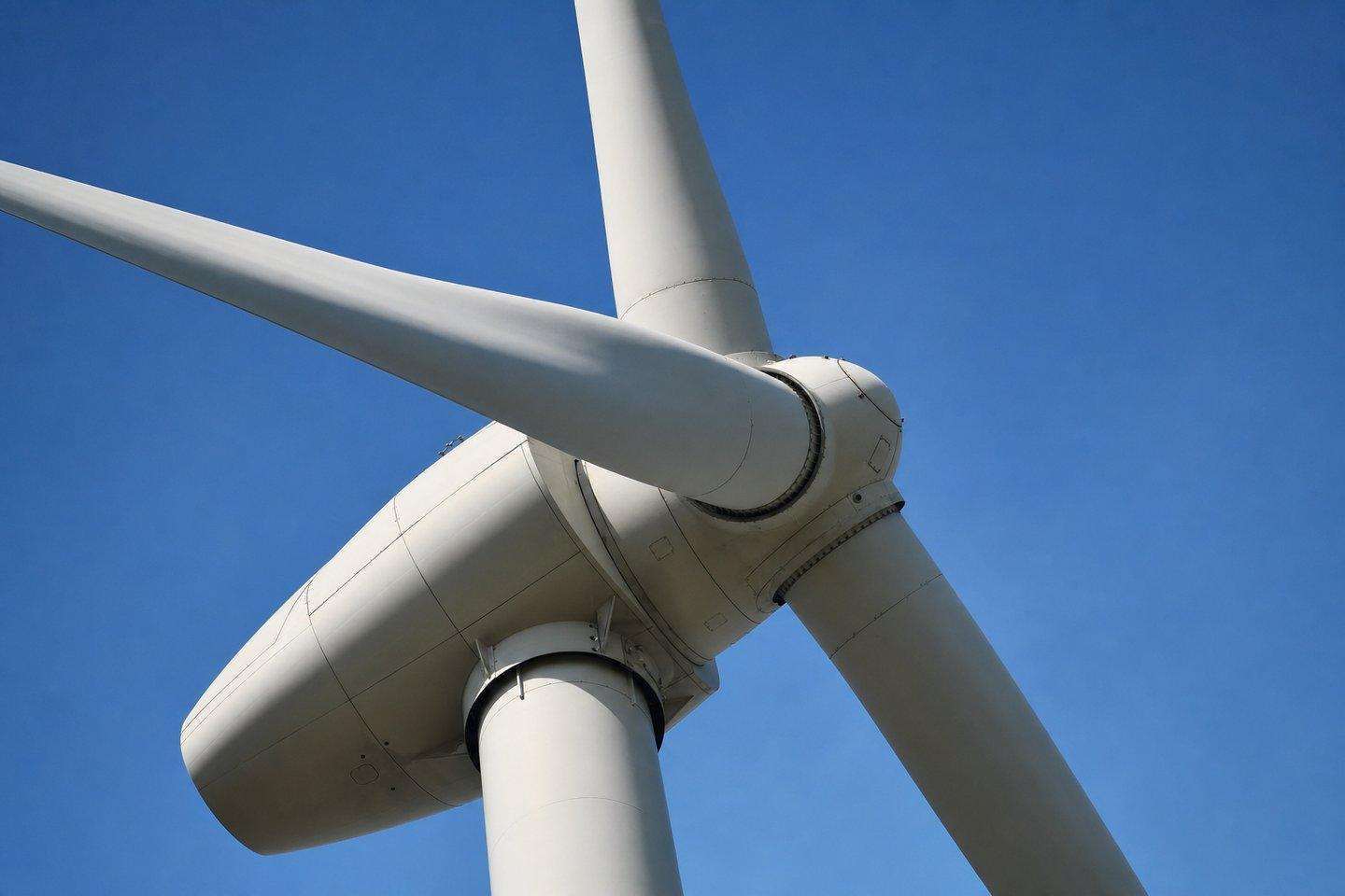 Close-up of a modern wind turbine blade against a clear blue sky